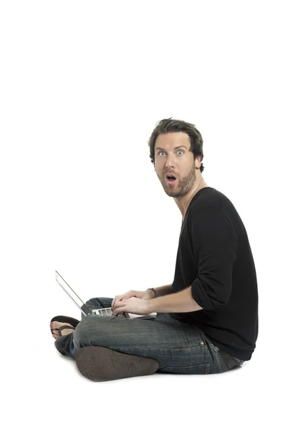 A surprised man using laptop — Stock Photo, Image