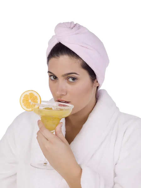 A woman wearing bathrobe drinking martini — Stock Photo, Image