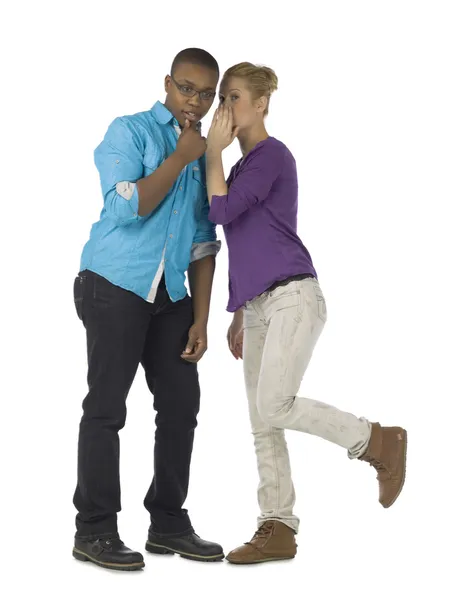 A woman whispering to her boyfriend — Stock Photo, Image