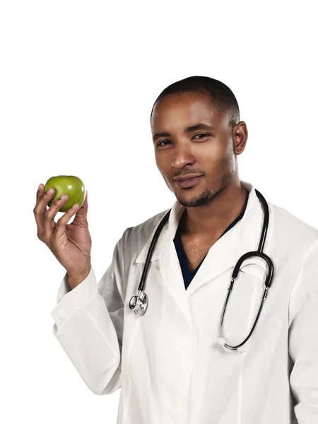 African american young doctor holding green apple — Stock Photo, Image