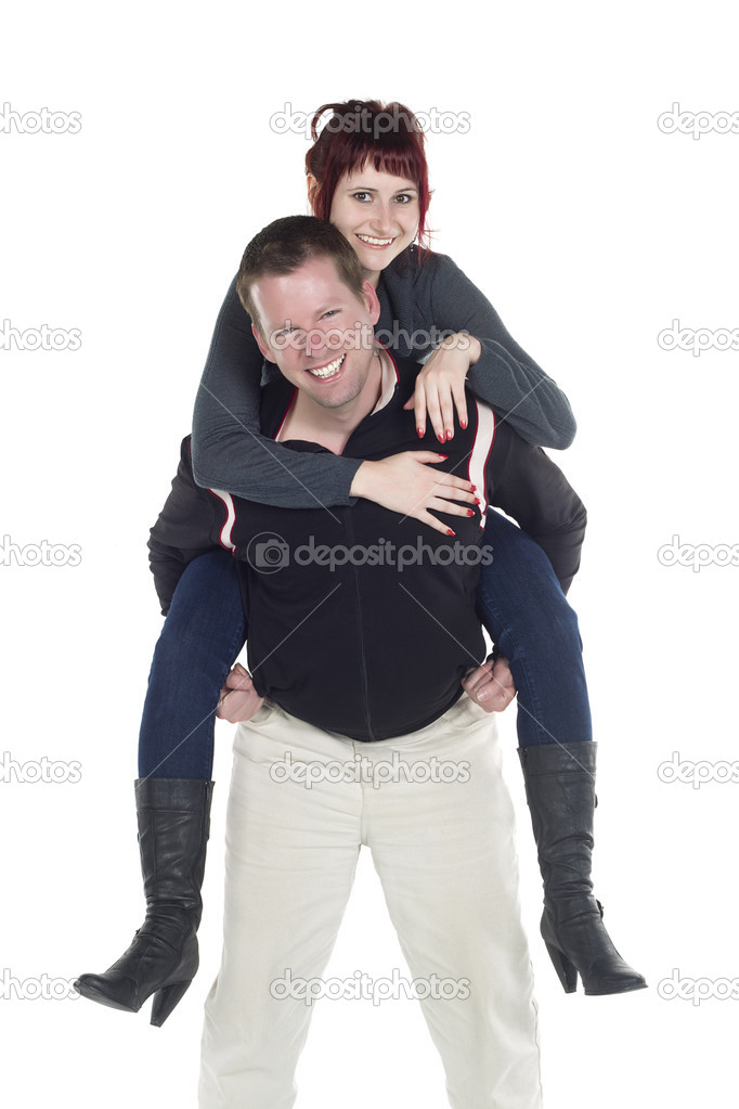 a happy husband giving his wife a piggy back ride