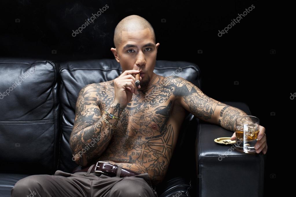 african american mafia boss smoking a cigar while having african american mafia boss smoking a cigar while having