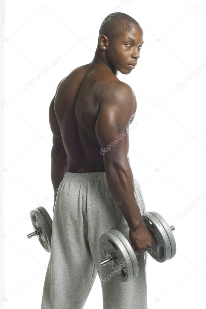 african american man with dumbbell looking at camera