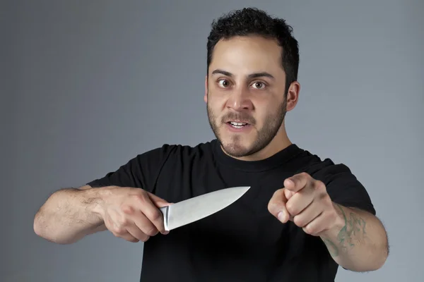 An angry man holding a knife — Stock Photo, Image