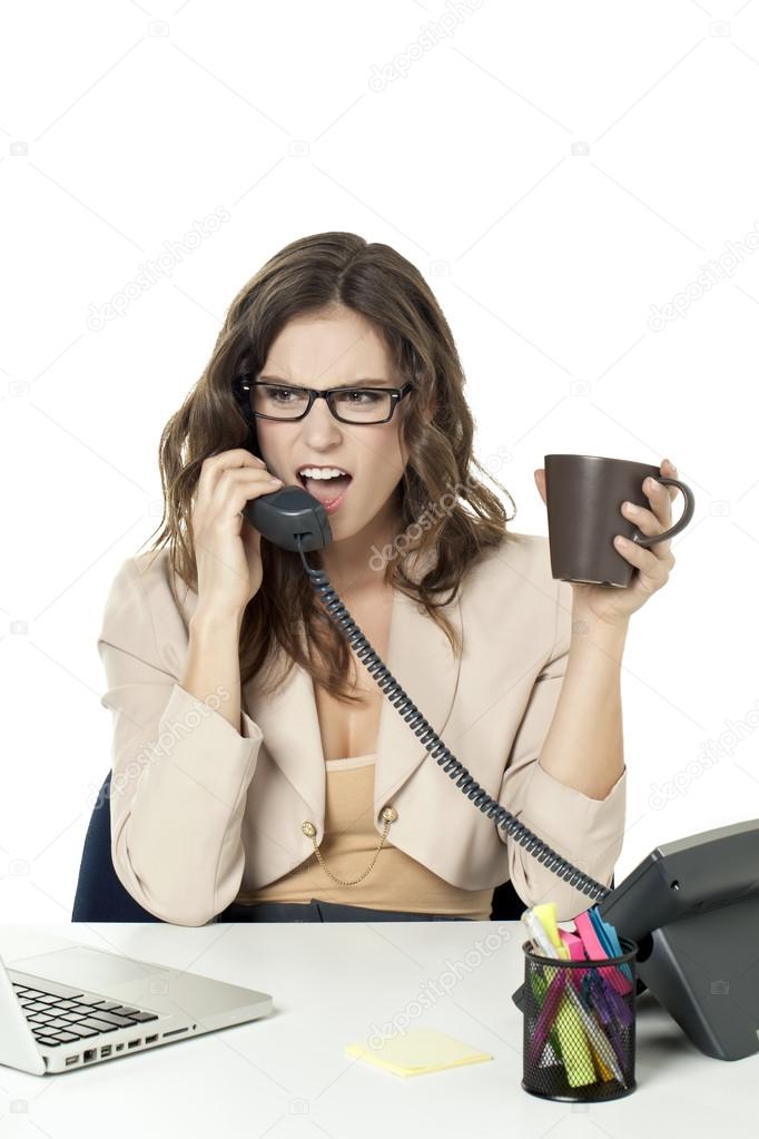 an angry businesswoman answering phone call