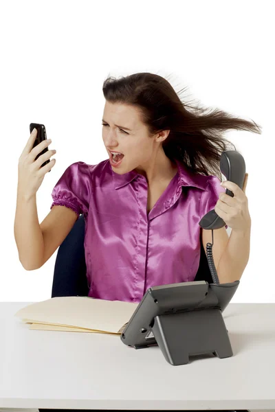 Angry businesswoman answering calls — Stock Photo, Image