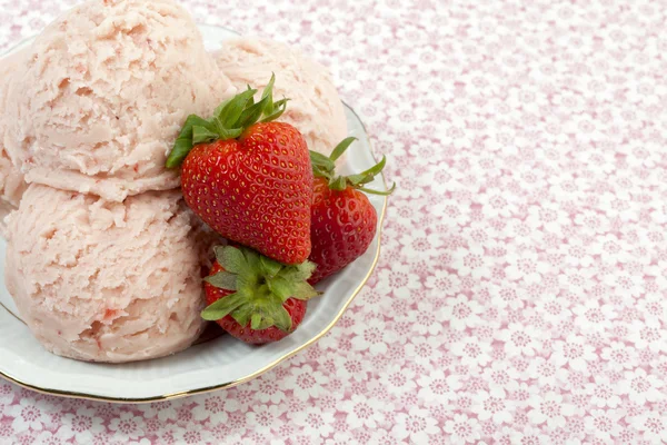 Una cucharada de helado de fresa en un plato con frutas — Foto de Stock