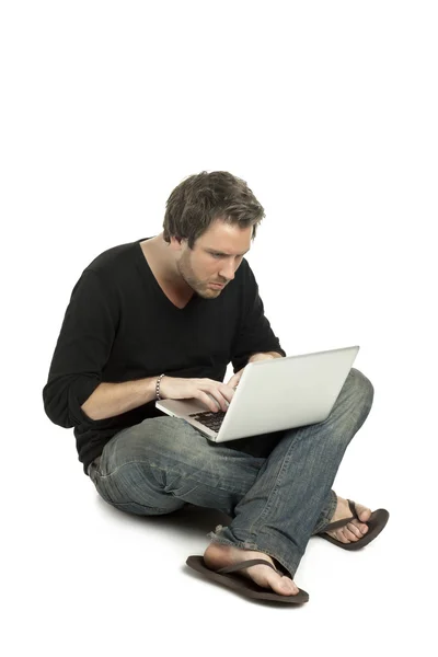 A man seriously using his laptop — Stock Photo, Image