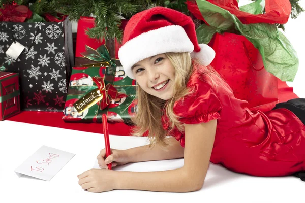 A girl writing her christmas list to santa — Stock Photo, Image