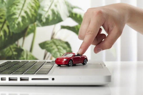 A hand playing red toy car — Stock Photo, Image