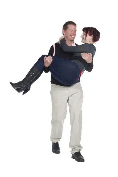 A handsome man carrying a woman in his arm — Stock Photo, Image