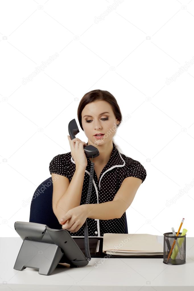 a secretary dialing on the telephone