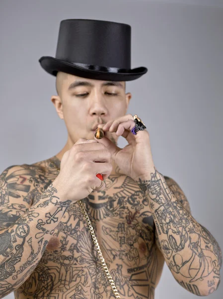 A smoking young man with tattoo — Stock Photo, Image