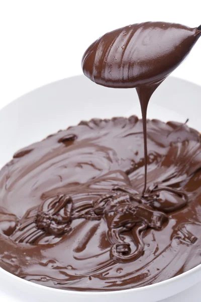 A spoon scoop in melted chocolate — Stock Photo, Image