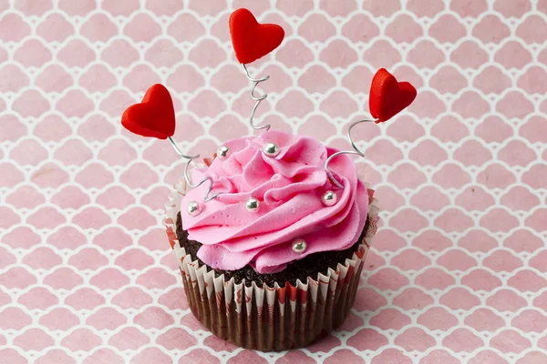 Ένα cupcake φράουλα με σχήματα καρδιών και χάντρες — Φωτογραφία Αρχείου
