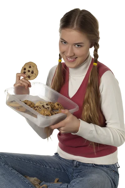 A teenage girl holding a tupperware of cookies — Stock Photo, Image