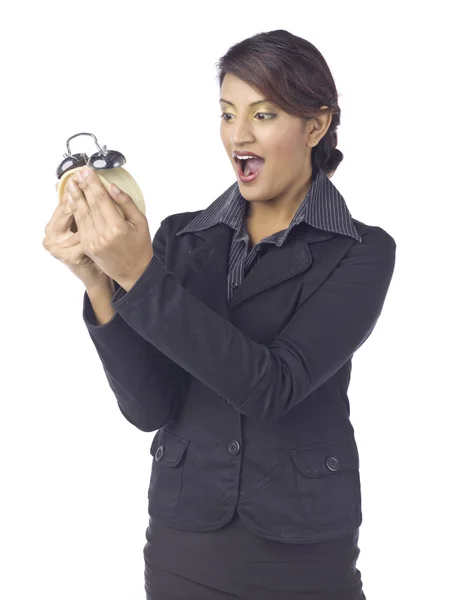 A shocked businesswoman holding alarm clock — Stock Photo, Image