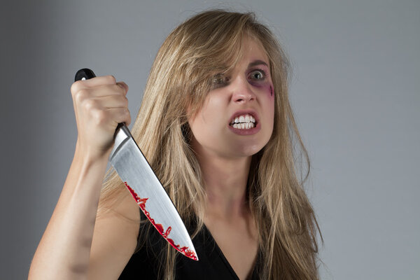 abuse young woman holding a knife