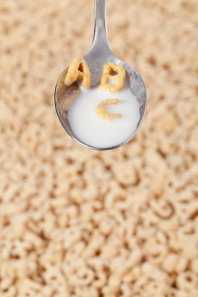 Alphabet cereals and spoon — Stock Photo, Image
