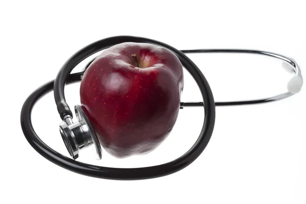Apple and stethoscope on white background — Stock Photo, Image