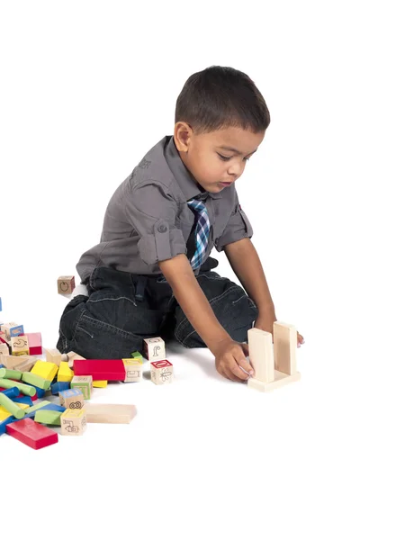 Asian elementary aged boy playing with toys — Stock Photo, Image