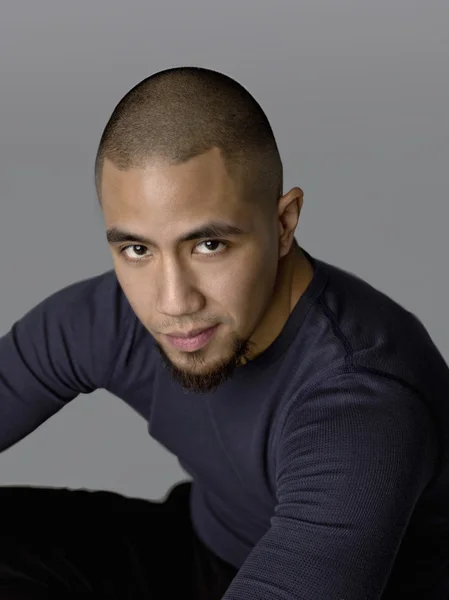 Attractive man sitting looking at the camera — Stock Photo, Image