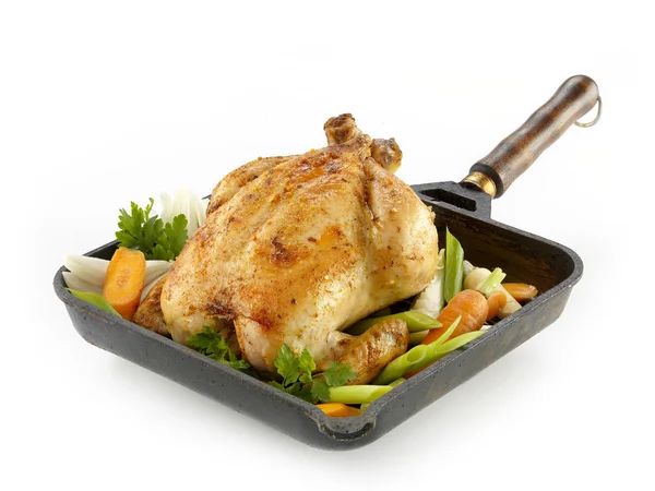 Whole roasted chicken with vegetables on the white backround Royalty Free Stock Photos