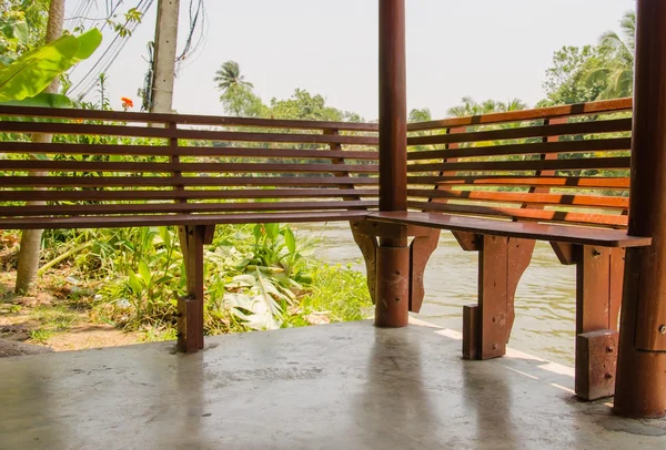 Chair beside the river. — Stock Photo, Image