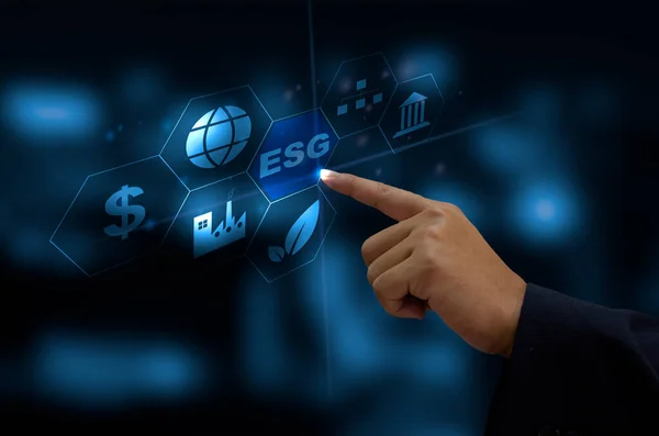 Environmental, social, and governance (ESG) investment Organizational growth. Business man hand touching the ESG word  icon on a virtual screen.
