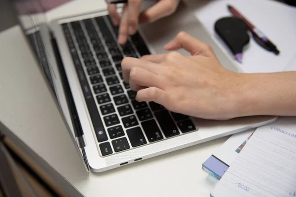 Woman hand using keyboard computer laptop internet communication social network digital technology.