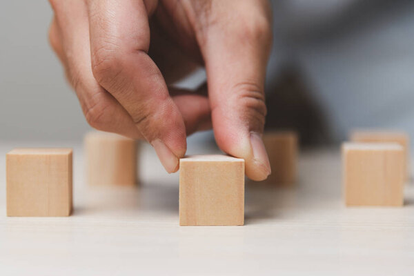Hand holding wood cube block.Business growth success concept.