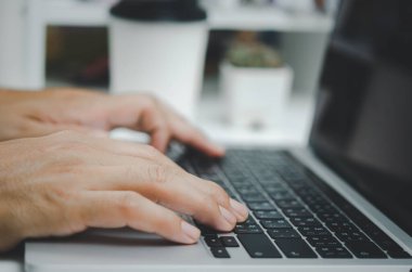 Person man hand typing keyboard computer communication internet online information and searching social digital marketing concept.