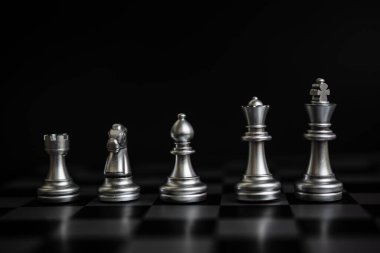 Chess game gold and silver on black background.