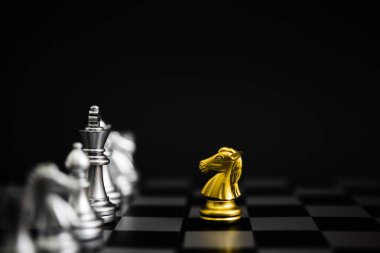 Chess game gold and silver on black background.