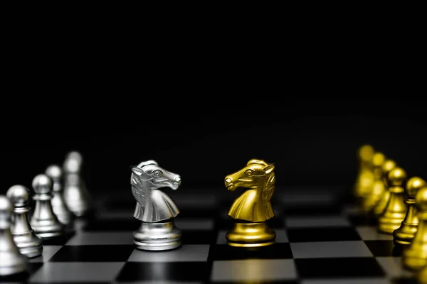 Chess game gold and silver on black background.