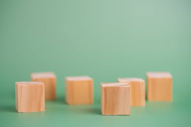 wood cube block blank on green background.