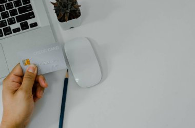 Man holding credit card business finance shopping online payment internet banking on background top view and fat lay.