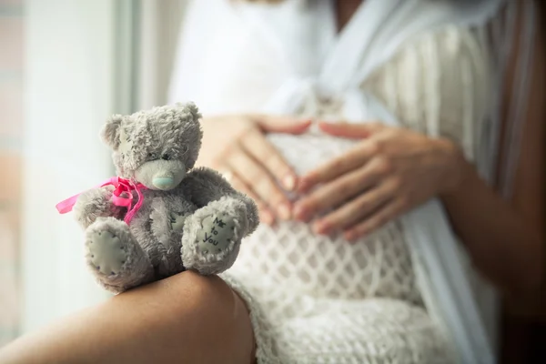 Toy on her knees — Stock Photo, Image