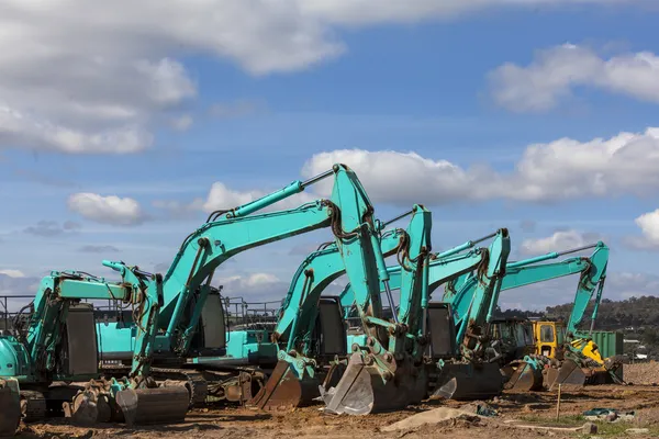 Green earthmoving machines ready for action — Stock Photo, Image