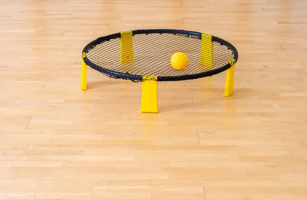 Spike ball game with yellow ball on hardwood court floor. Horizontal sport theme poster, greeting cards, headers, website and app