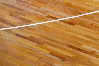 Spor salonunun zemininde beyaz çizgi var. Badminton, Futsal, Voleybol ve Basketbol sahası