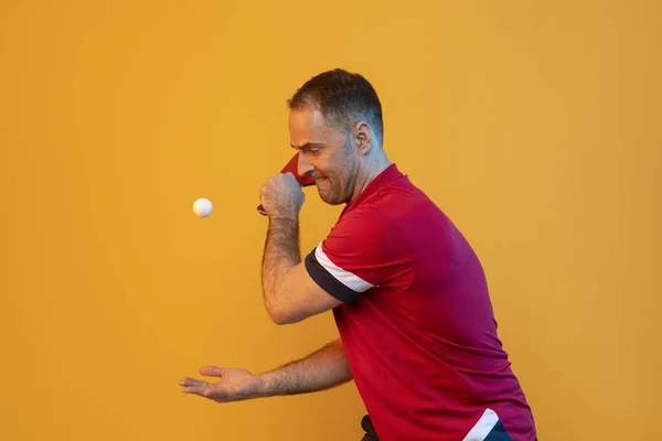 Man plays table tennis on yellow studio background. Professional player plays ping pong. Horizontal sport theme poster, greeting cards, headers, website and app