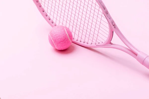 Pink tennis racket and pink ball on pink background. Horizontal sport theme poster, greeting cards, headers, website and ap