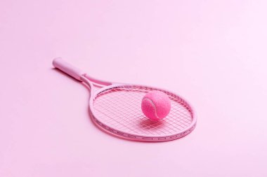 Pembe tenis raketi ve pembe arka planda pembe top. Yatay spor temalı poster, tebrik kartları, başlıklar, web sitesi ve ap