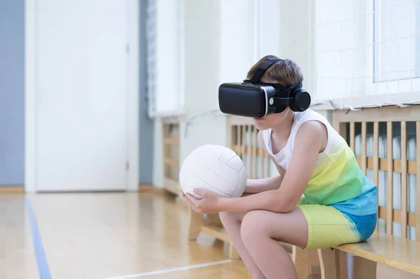 School kid with interactive glasses playing volleyball in a physical education lesson. Horizontal interactive sport theme poster, greeting cards, headers, website and app