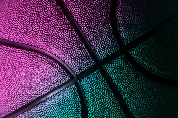 Closeup detail of basketball ball texture background. Neon banner art concept. Horizontal sport theme poster, greeting cards, headers, website and app