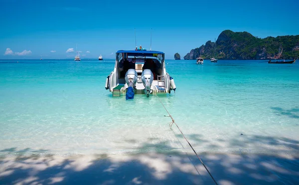 The Landscape of beach and ocean on a sunny day at Phi Phi Islands with a tourist boat, Thailand