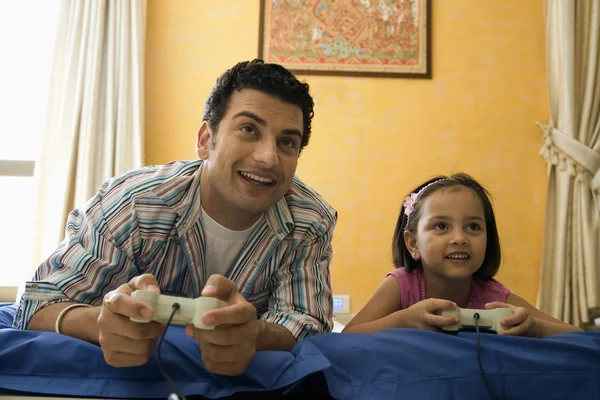 Children playing video game in bed - a Royalty Free Stock Photo