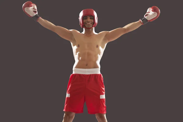 Boxer celebrating victory with raised hands — Stock Photo, Image