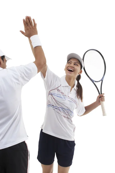 Happy tennis players doing high five — ストック写真